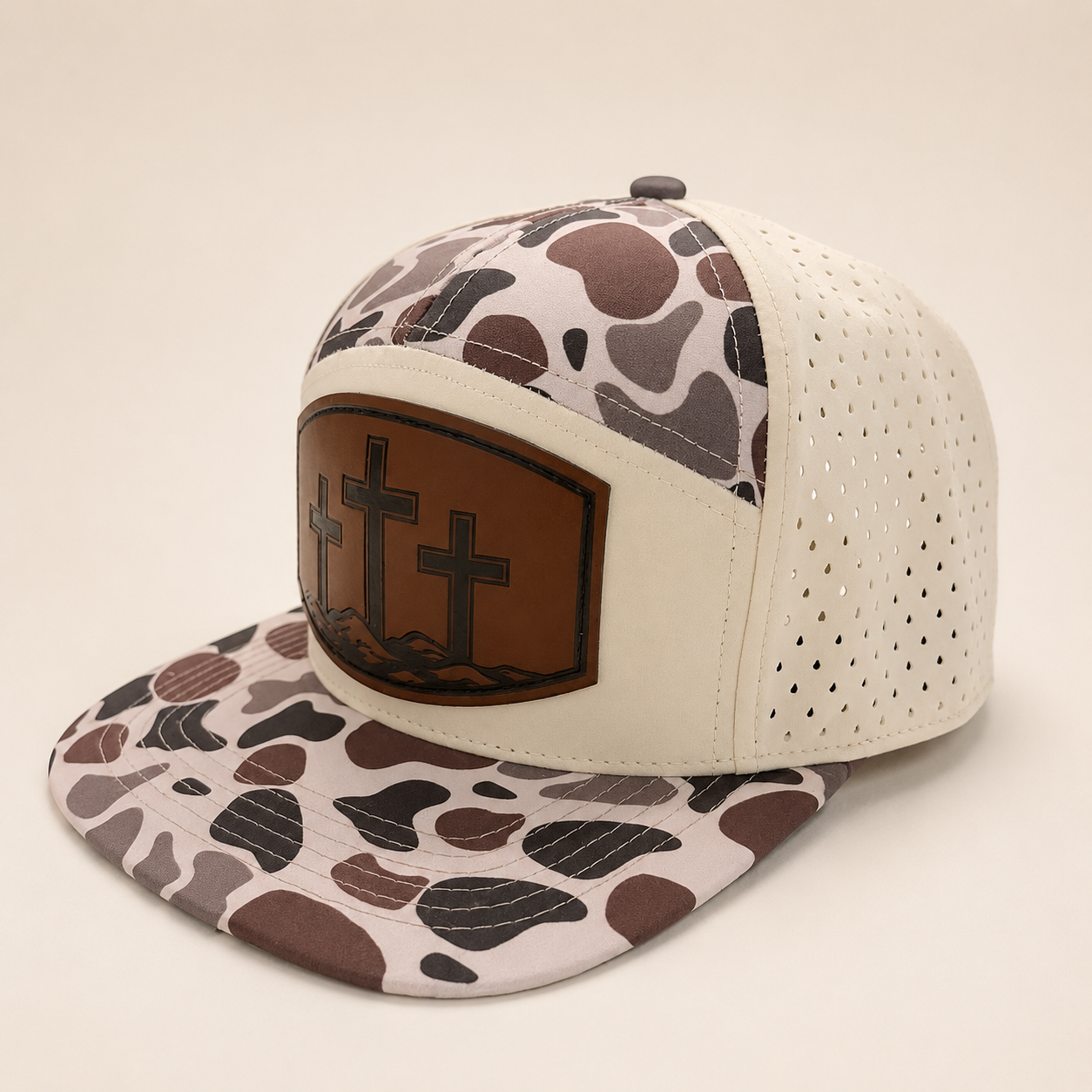 Camo and cream Three Cross hat, angled view showing the patterned brim and perforated side panels